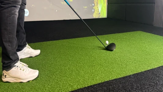 An 18mm black ultra turf with 10mm shocktech and a 2.8m by 1.4m tee turf nylon hitting strike mat supplied by Golf Sim Solutions for indoor golf simulators